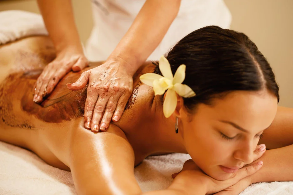 Therapist giving a full body massage in Phuket to a relaxed client at a Patong Beach spa